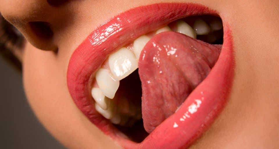 woman licking her teeth